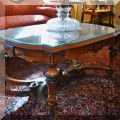 F10. Carved coffee table with burlwood center and inlay. 